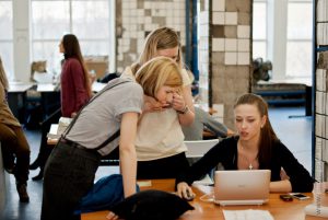 three women around a computer