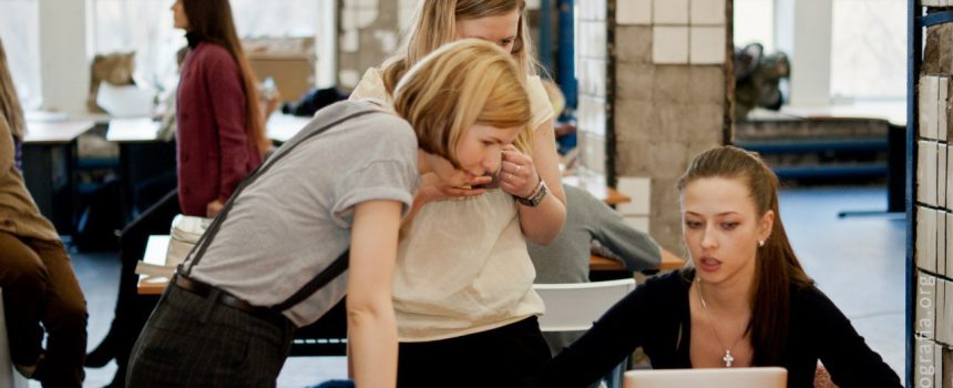 three women around a computer